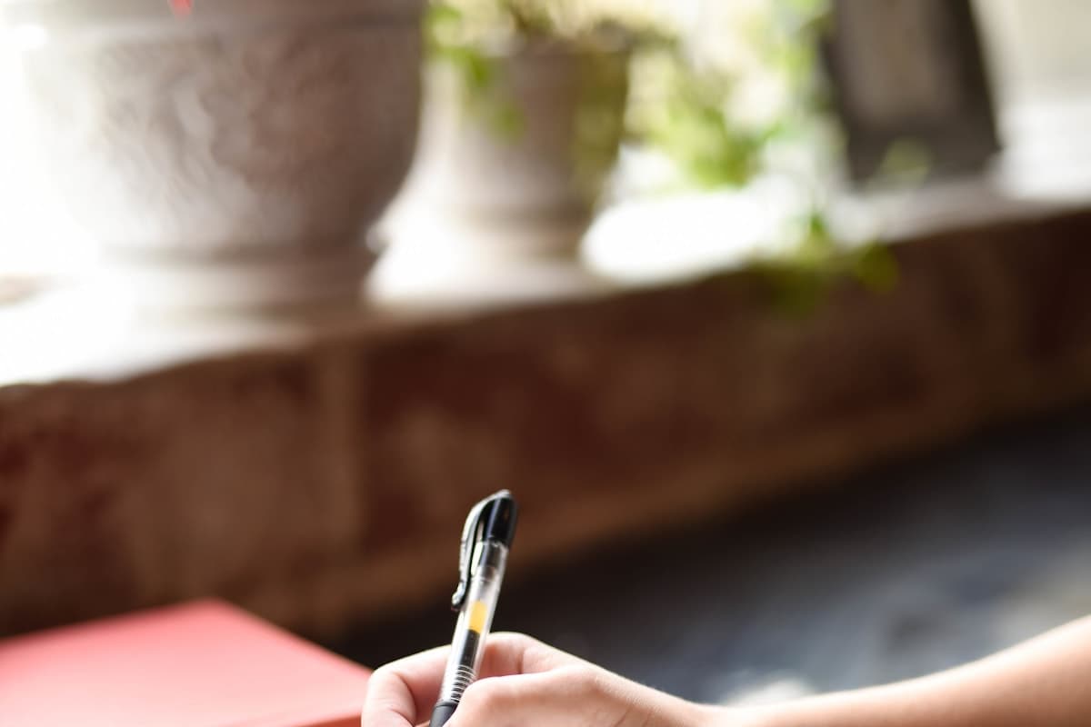يد تكتب ملاحظات في دفتر مفتوح